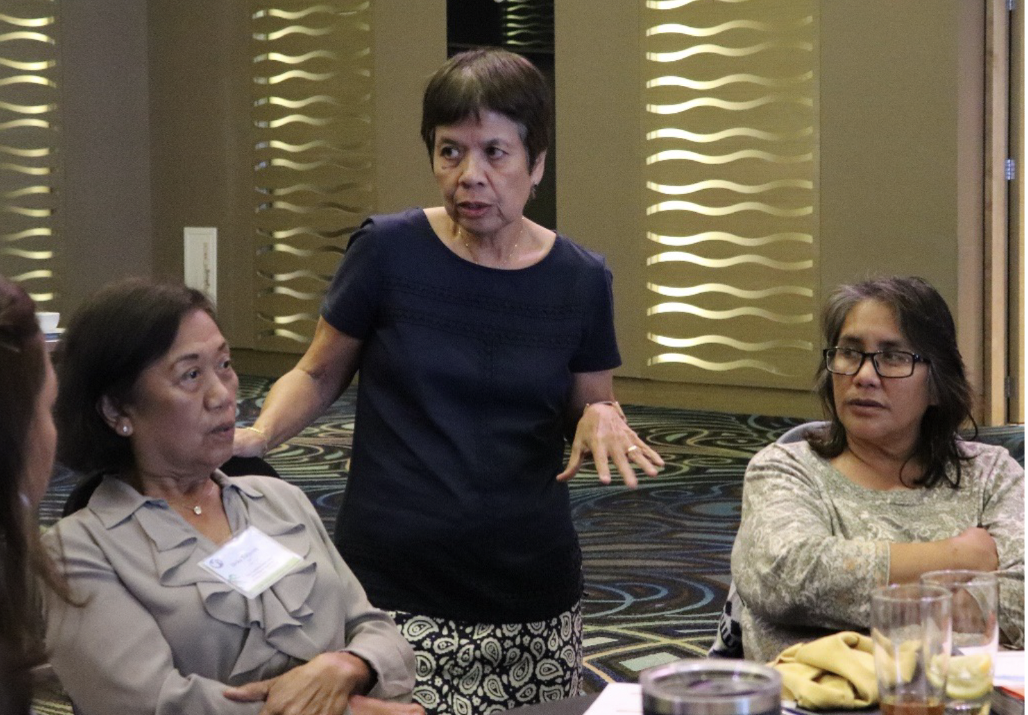 Nieves Flores, EdD, Consultant, Guam CEDDERS, (standing) pictured with Chief Brodie Memorial Elementary School’s faculty (left to right) Delia Taijeron, teacher and Celeste Lizama, teacher.